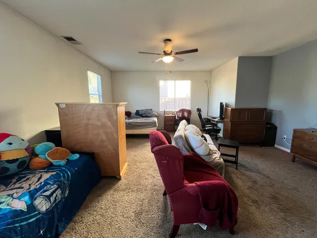 a living room with furniture chess board and a window