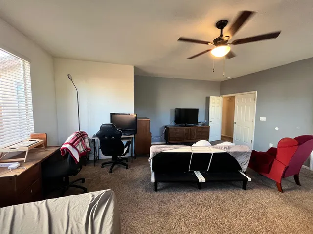 a bedroom with furniture and a window