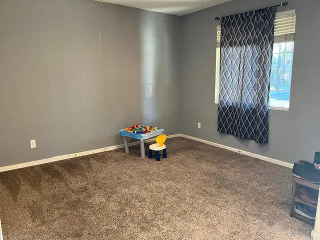 a view of a room with gym equipment and windows
