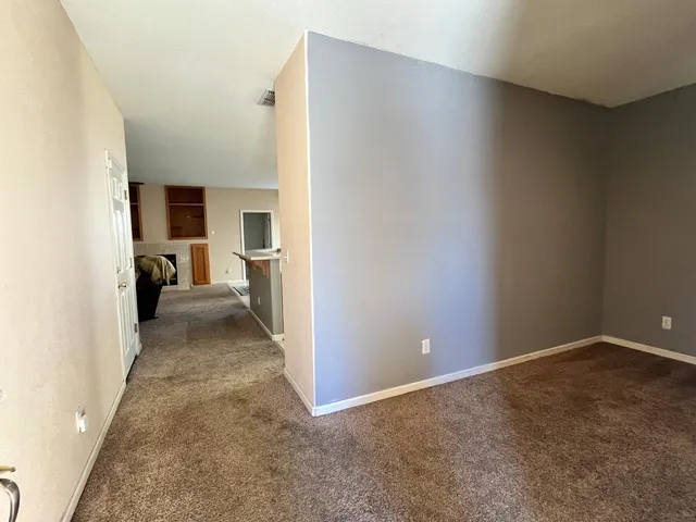 a view of a room with closet and a fireplace