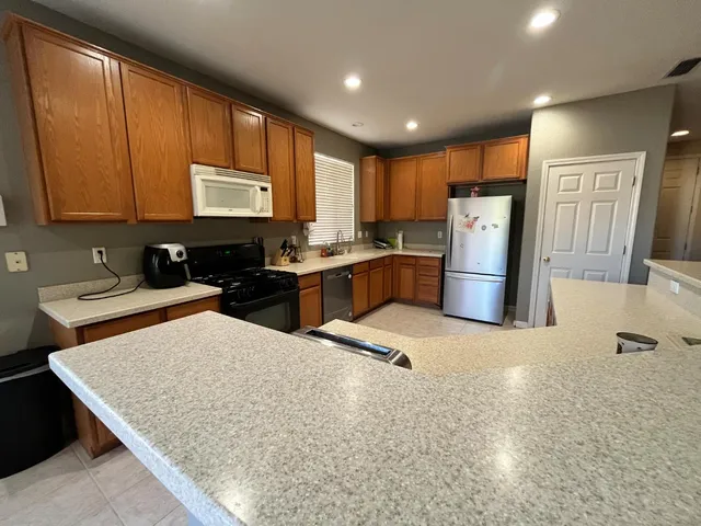 a kitchen with refrigerator and window
