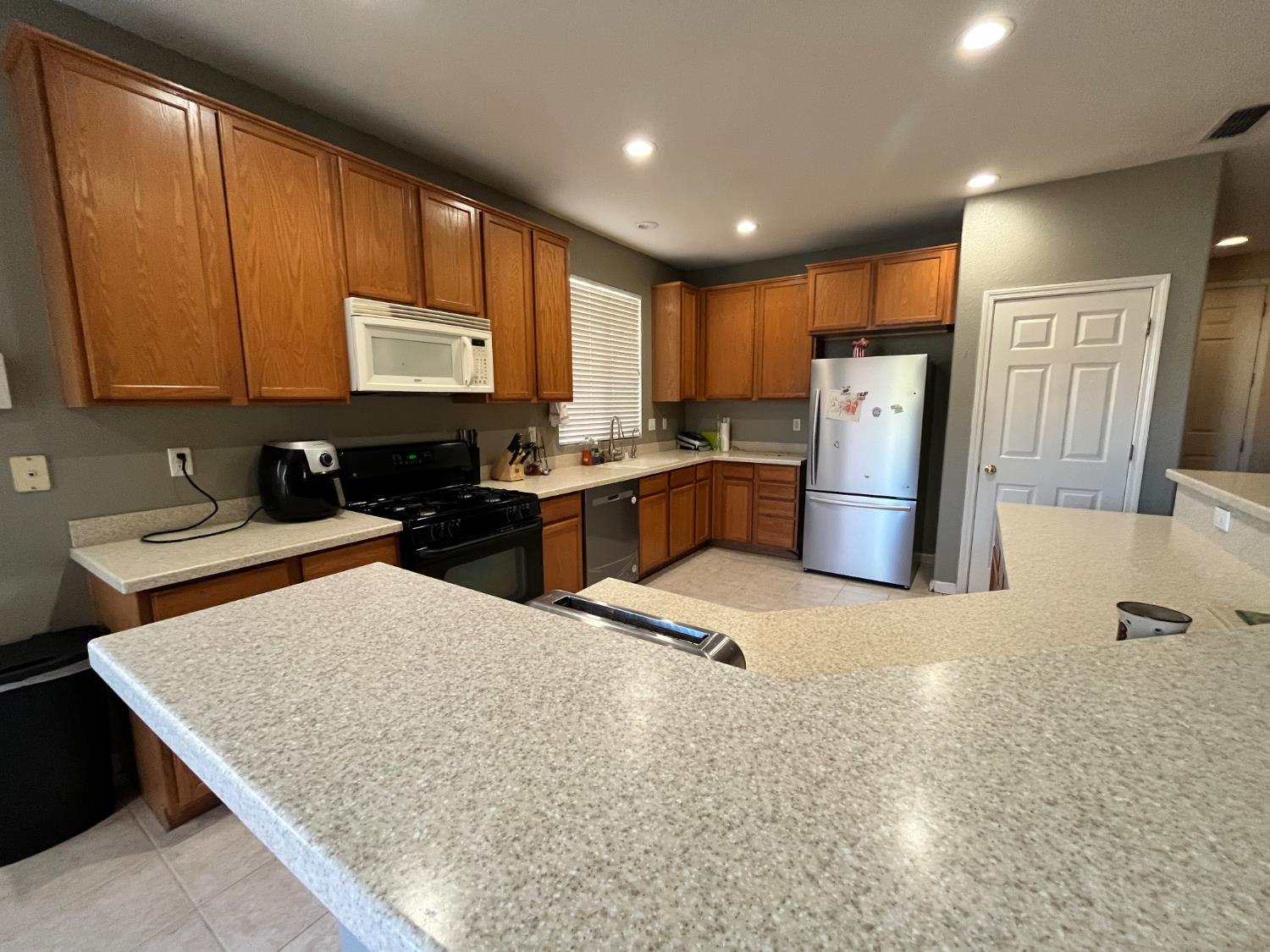 1117 Marsh Wren Court Patterson, CA 95363 - Photo 9 of 41 a kitchen with refrigerator and window