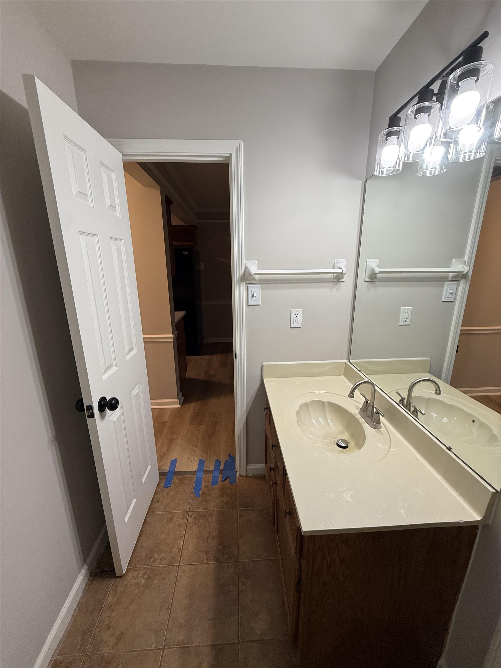 6913 Snyder Road Memphis, TN 38141 - Photo 18 of 20 Bathroom vanity with a scalloped sink, integrated countertop, and wood-finish cabinetry