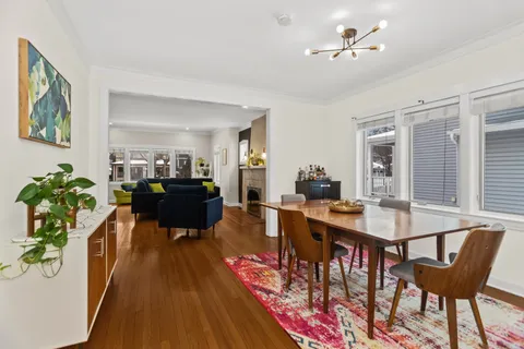 a view of a dining room with furniture window and wooden floor