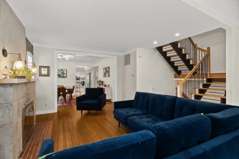 a living room with furniture and wooden floor