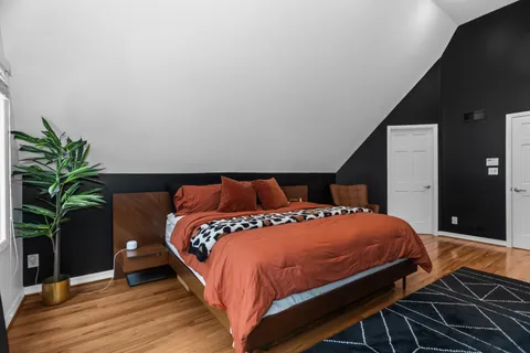 a bedroom with a bed and a potted plant