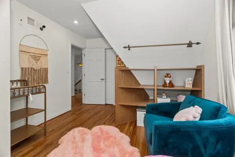 a view of entryway and hall with wooden floor