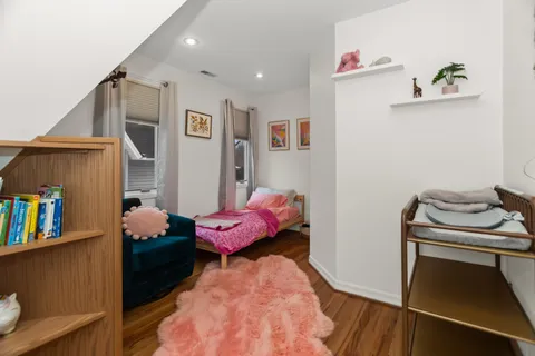 a bedroom with a bed and a book shelf