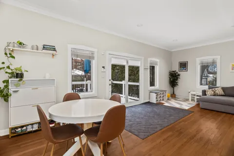 a dining room with furniture and wooden floor