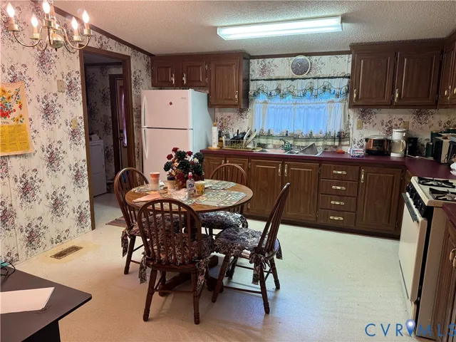 a kitchen with a table chairs and a refrigerator