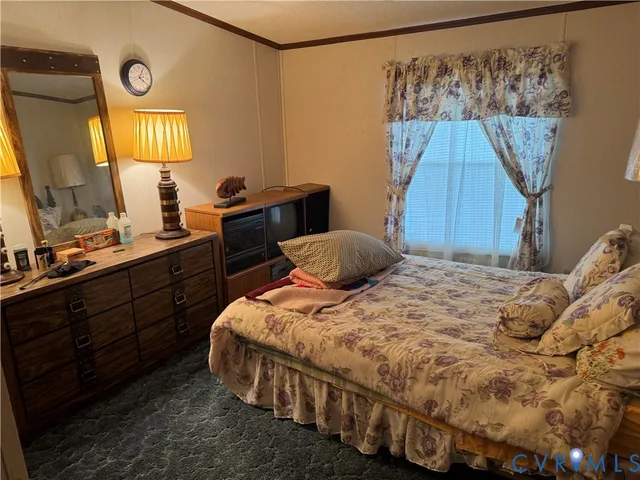 a bedroom with a bed and a mirror