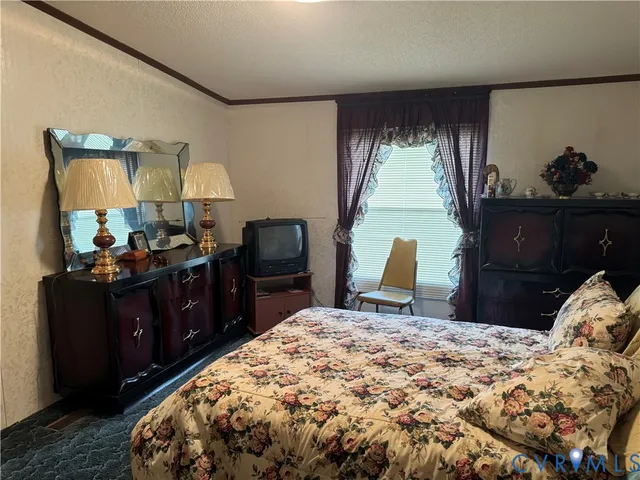 a bed room with a bed and a television