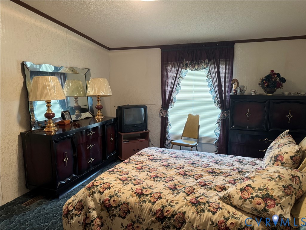 832 Evans Creek Road Brodnax, VA 23920 - Photo 7 of 13 a bed room with a bed and a television
