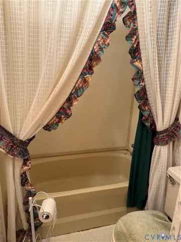 a bathroom with a bathtub and shower