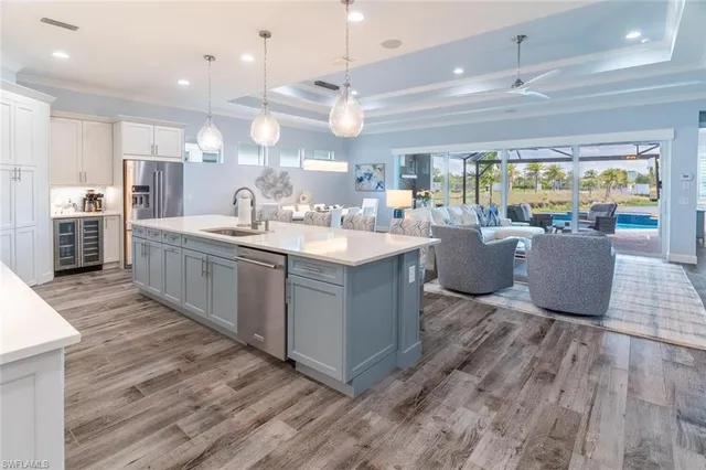 a large room with kitchen island a large island in the center