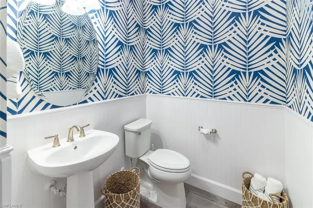 a bathroom with a sink a mirror and a toilet