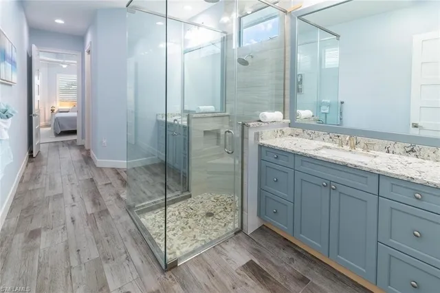 a bathroom with a shower sink and mirror