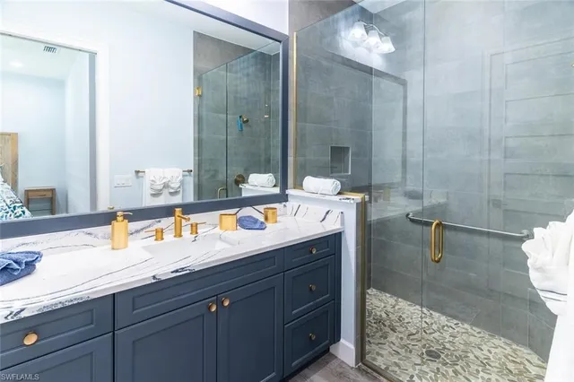 a bathroom with a sink double vanity and a mirror