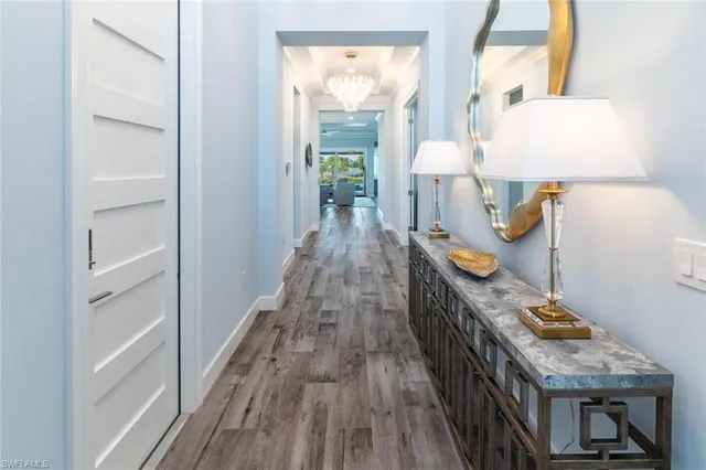 a view of hallway with wooden floor