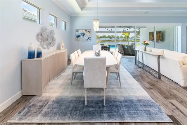 a dining room with furniture a rug and wooden floor