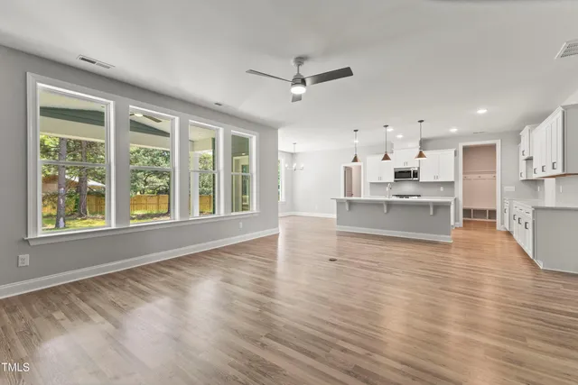 a large kitchen with kitchen island a sink stainless steel appliances and cabinets