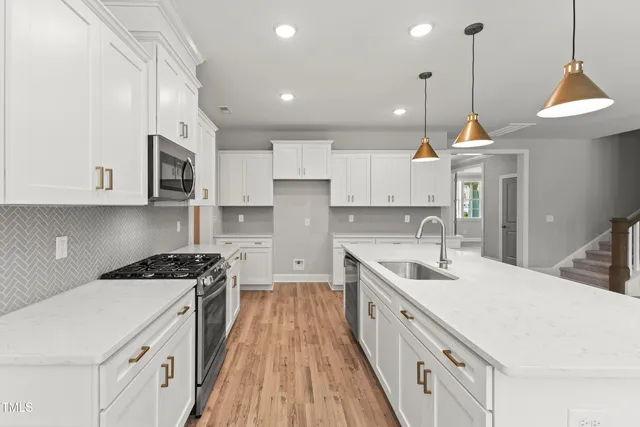 a kitchen with sink stove and window