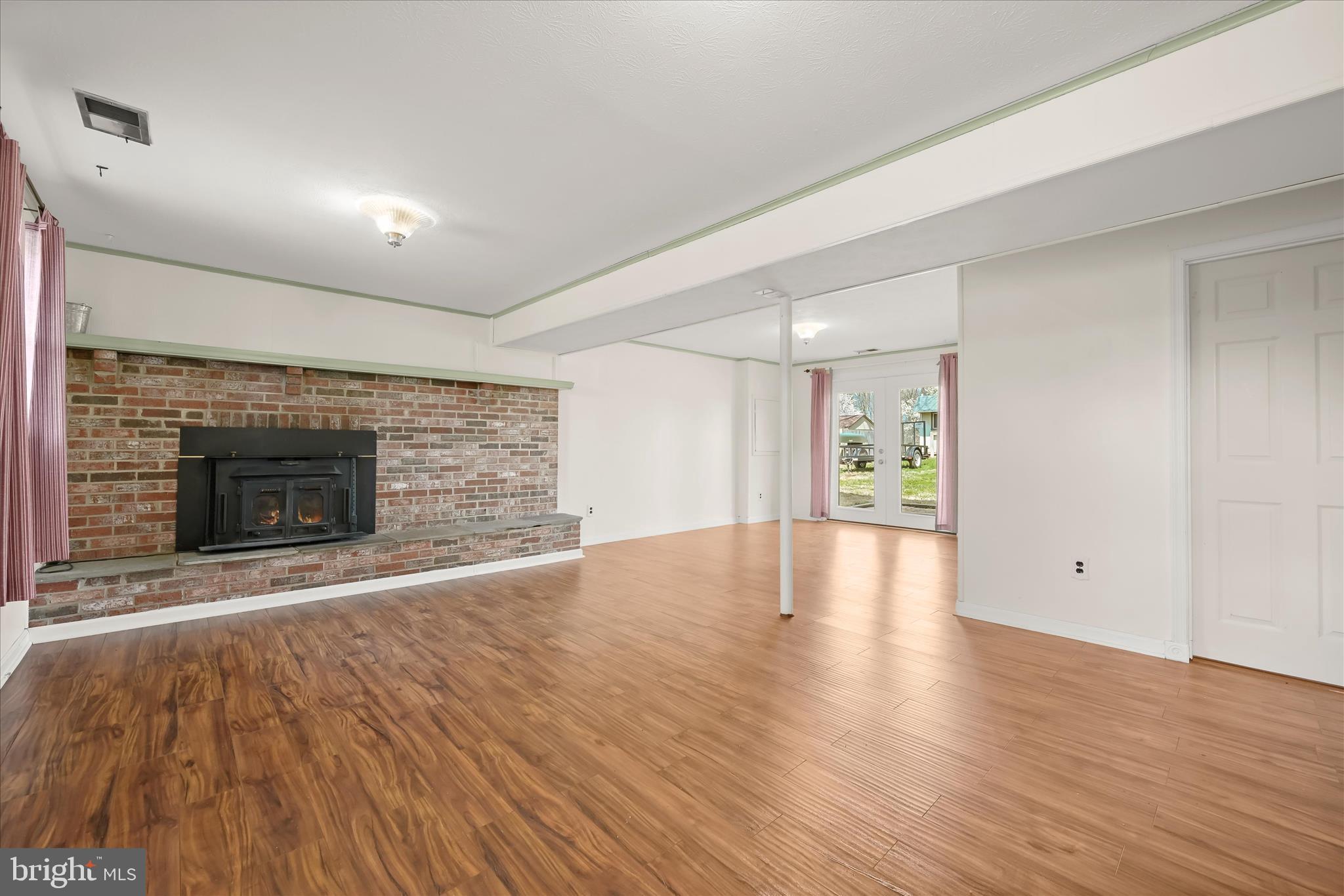 14821 Ridge Oak Drive Boyds, MD 20841 - Photo 5 of 49 an empty room with wooden floor and fireplace