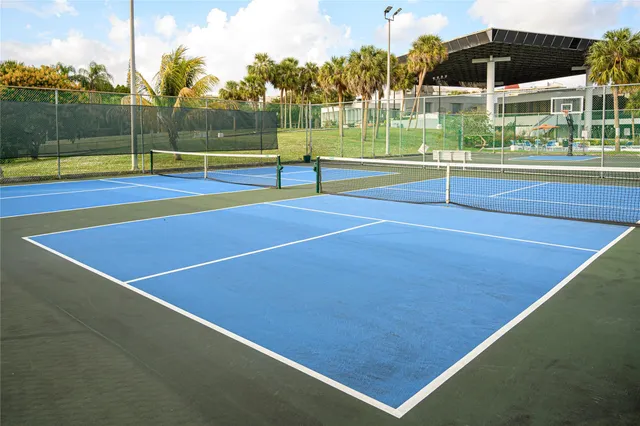 a view of a swimming pool with a lawn chairs under an umbrella