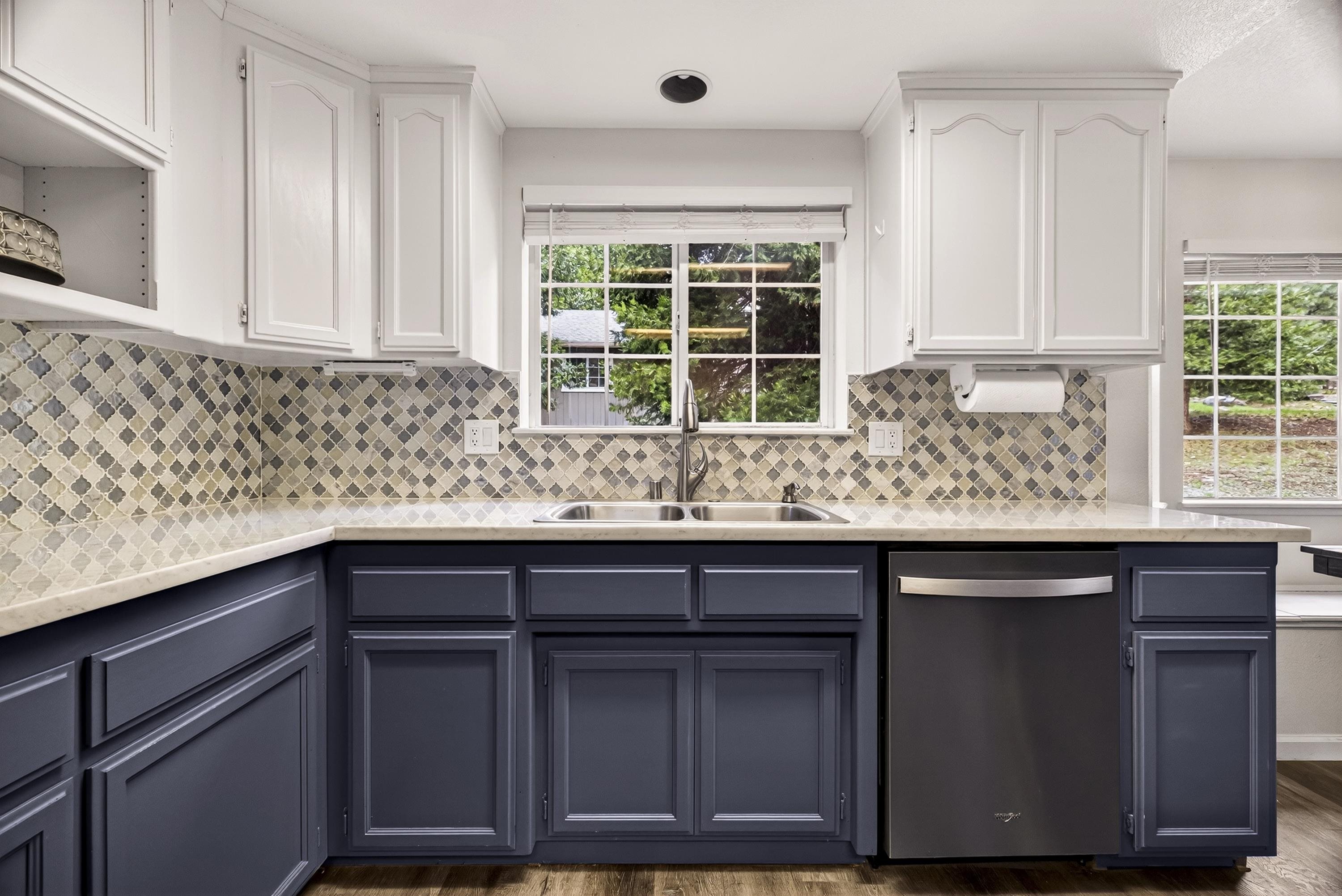 811 Golf Club Road Lake Almanor, CA 96137 - Photo 10 of 42 a kitchen with granite countertop wooden cabinets a sink and a window
