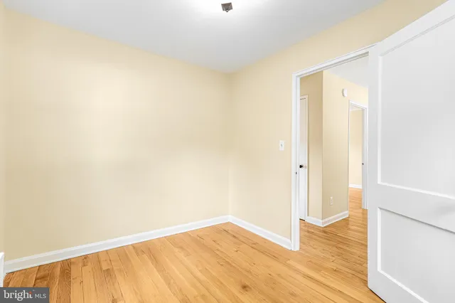 a view of an empty room with wooden floor