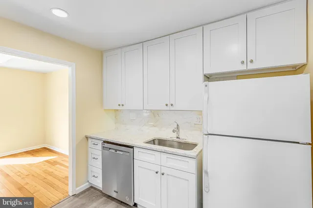 a kitchen with stainless steel appliances granite countertop white refrigerator stove a sink and dishwasher