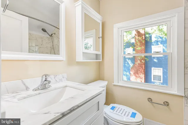 a bathroom with a sink and a window