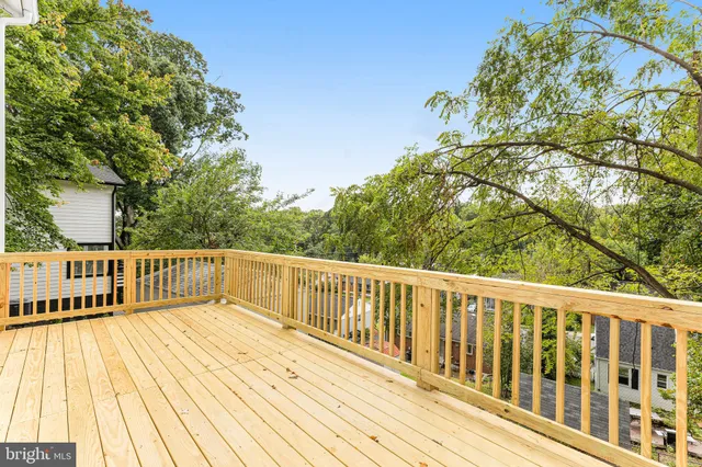 a view of balcony with wooden floor and fence