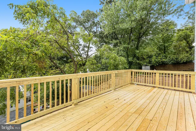 a balcony with wooden floor and fence