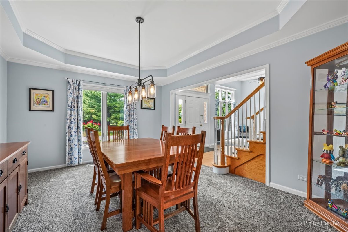 7104 Dove Way Cary, IL 60013 - Photo 10 of 82 a view of a dining room with furniture window and wooden floor