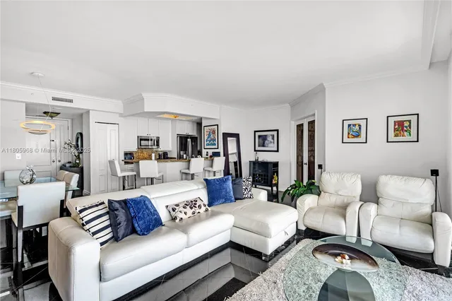 a living room with furniture and a view of bedroom