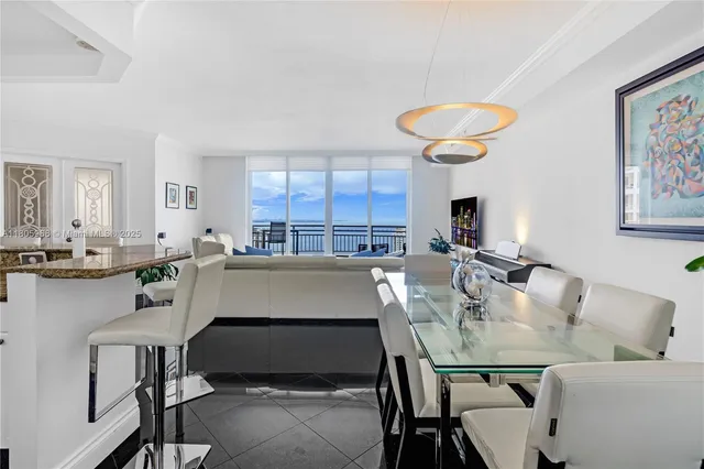 a kitchen with a table chairs sink and cabinets