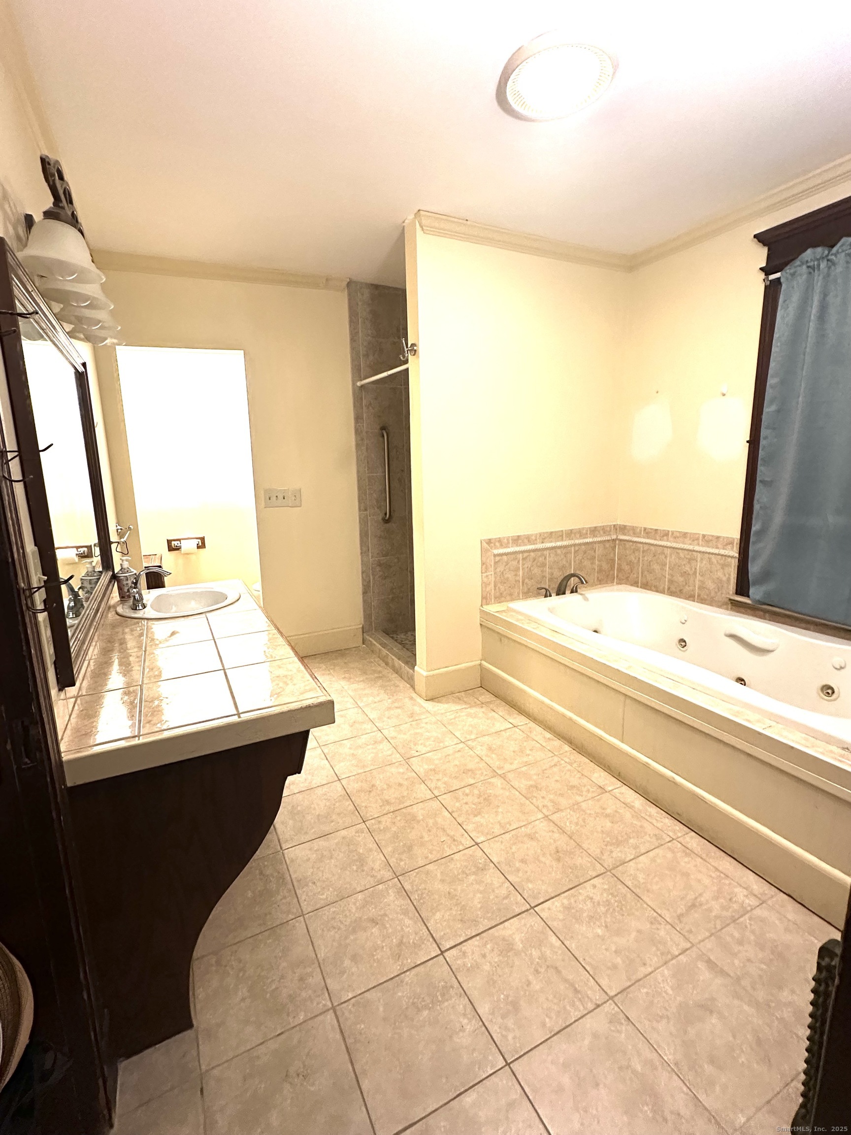 24 Maynard Avenue Waterbury, CT 06708 - Photo 15 of 32 a bathroom with a sink mirror and a bathtub