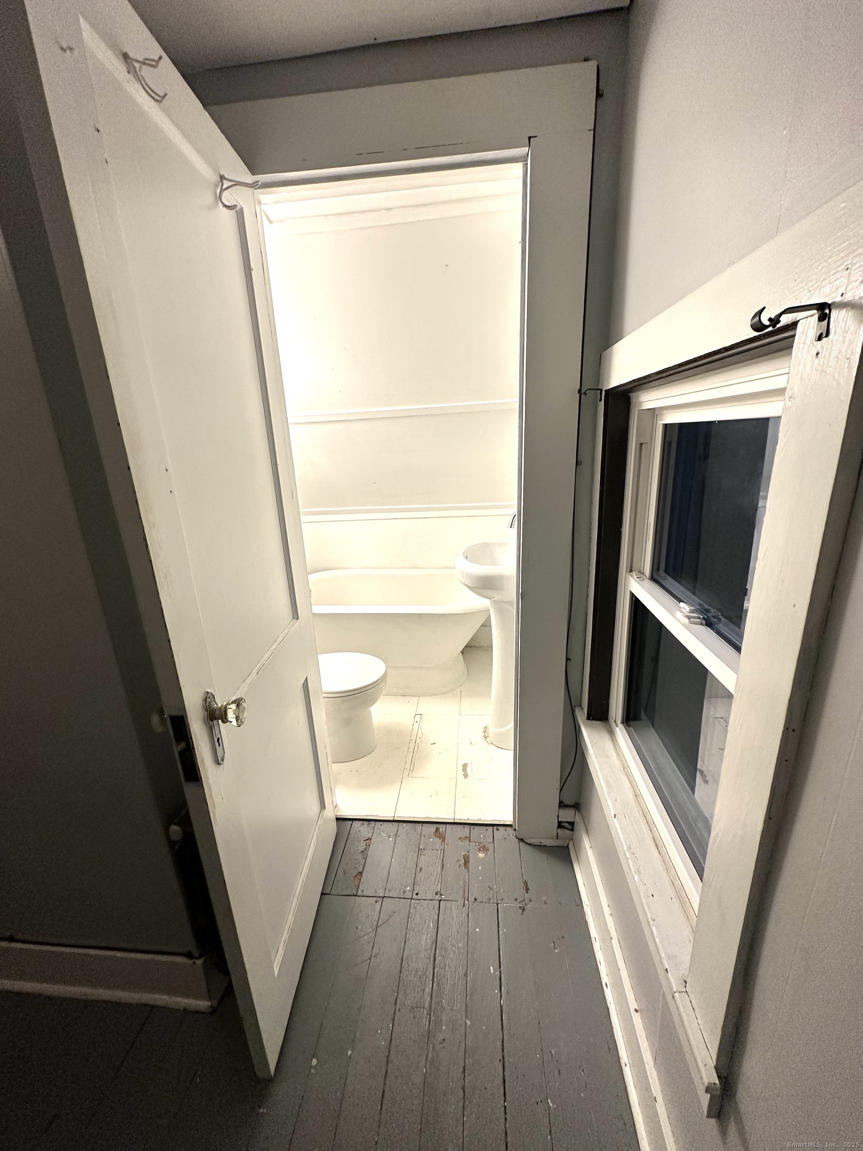 24 Maynard Avenue Waterbury, CT 06708 - Photo 16 of 32 a view of an empty room with wooden floor and door