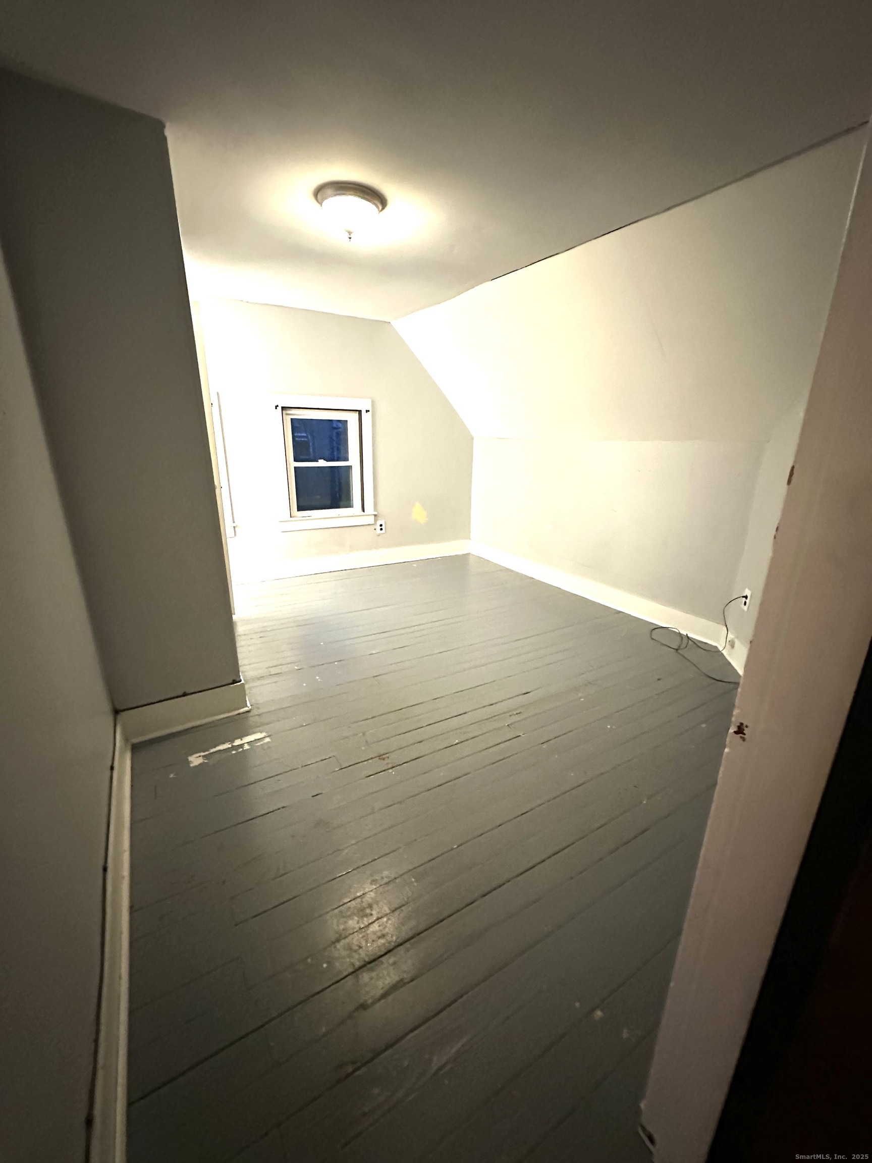 24 Maynard Avenue Waterbury, CT 06708 - Photo 17 of 32 a view of a big room with wooden floor and windows