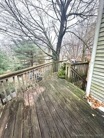 a view of balcony with wooden floor and fence