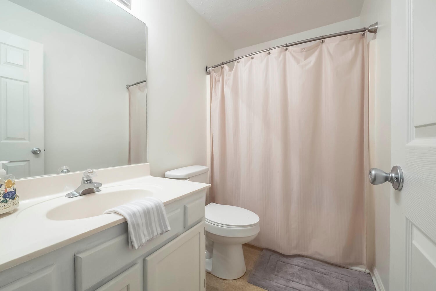 131 Gaskins Road Burns, TN 37029 - Photo 15 of 25 a bathroom with a sink a toilet and shower curtain