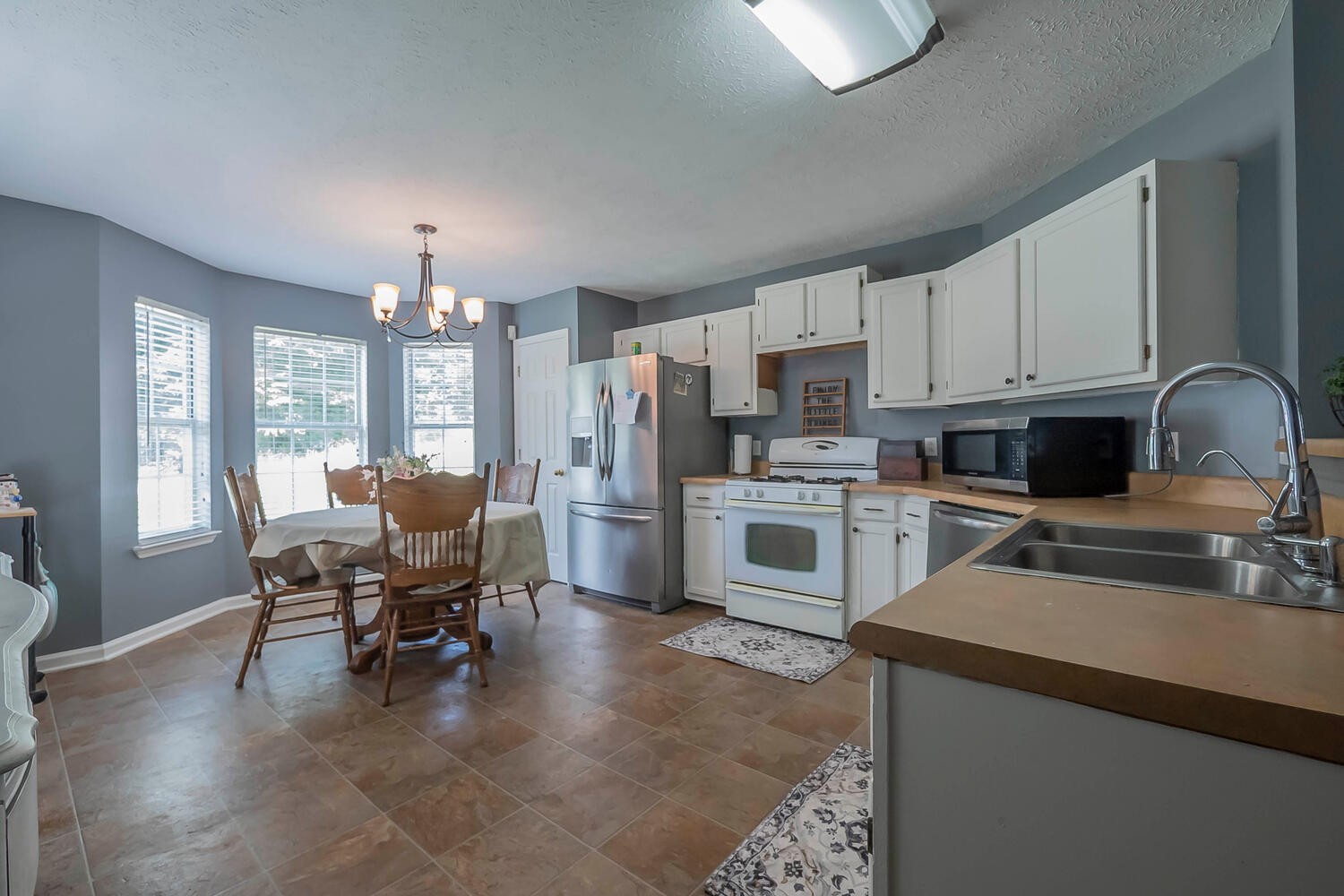 131 Gaskins Road Burns, TN 37029 - Photo 7 of 25 a kitchen with cabinets a sink and appliances