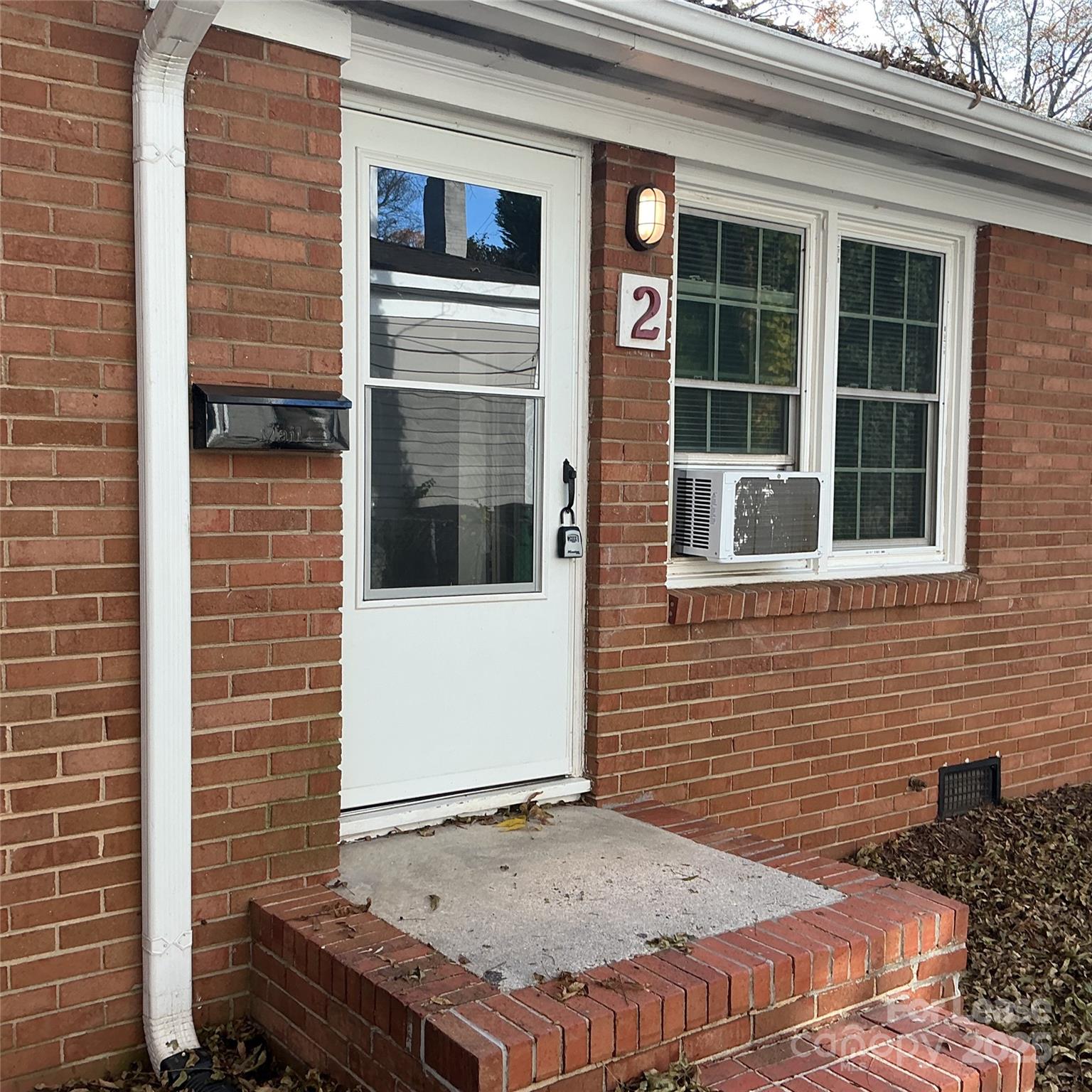 218 Grandin Road, Unit 2 Charlotte, NC 28208 - Photo 2 of 8 a view of a brick house with a door and wooden door