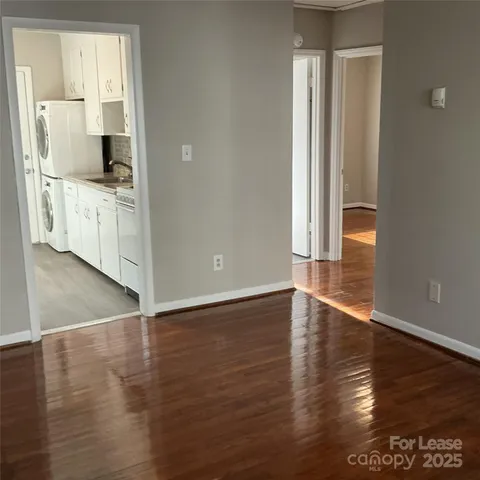 a view of a kitchen with wooden floor and a sink