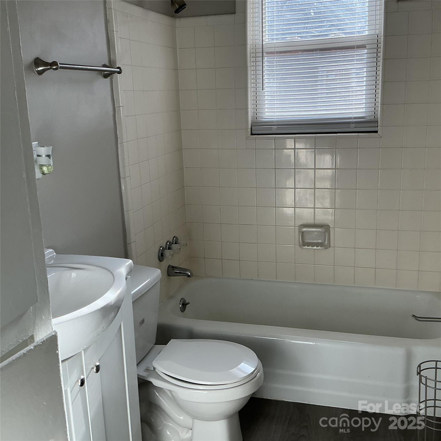 218 Grandin Road, Unit 2 Charlotte, NC 28208 - Photo 8 of 8 a bathroom with a sink a toilet and bathtub