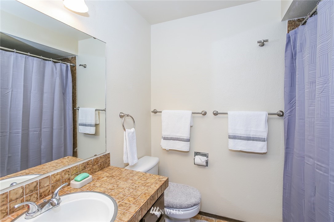 17848 156th Place Southeast Renton, WA 98058 - Photo 12 of 24 a bathroom with a granite countertop sink toilet and shower