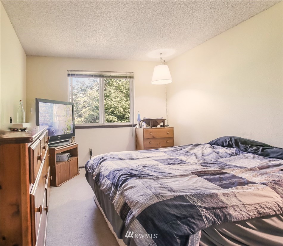 17848 156th Place Southeast Renton, WA 98058 - Photo 14 of 24 a bedroom with a bed and wooden floor