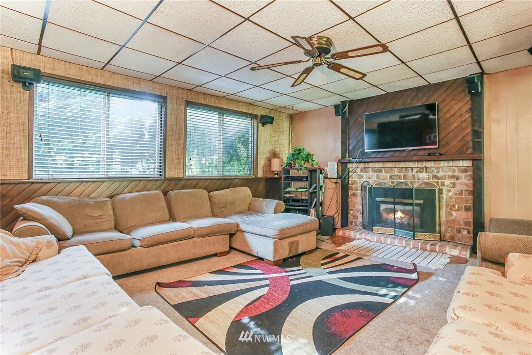 17848 156th Place Southeast Renton, WA 98058 - Photo 15 of 24 a living room with furniture a flat screen tv and a fireplace