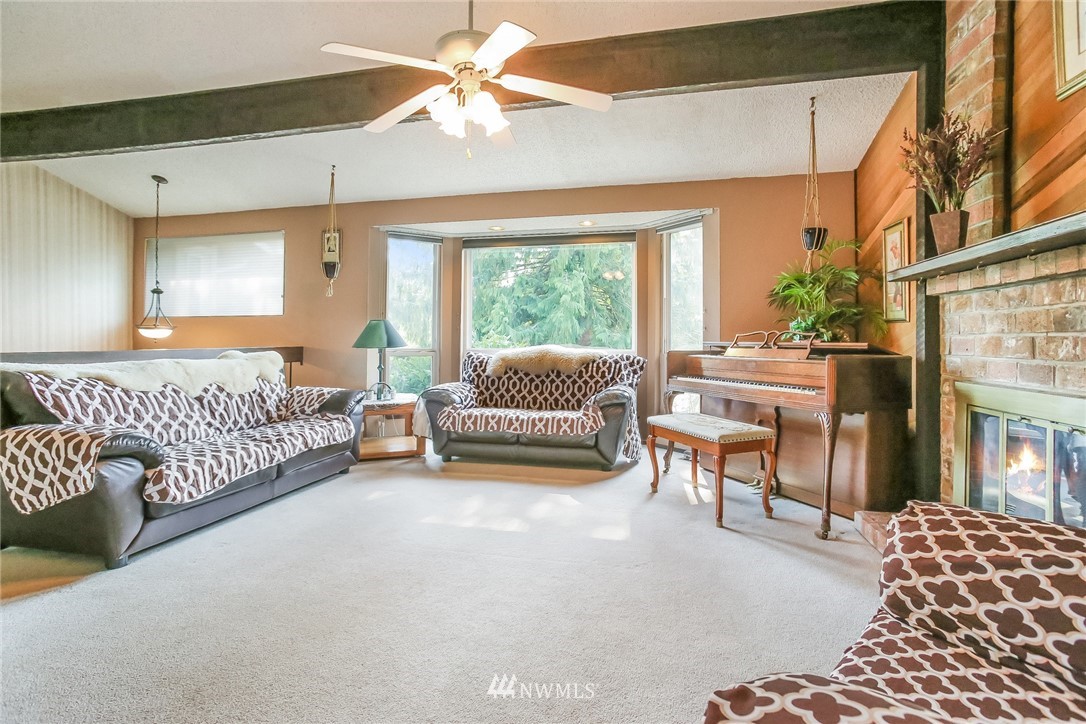 17848 156th Place Southeast Renton, WA 98058 - Photo 3 of 24 a spacious bedroom with a bed and a chandelier